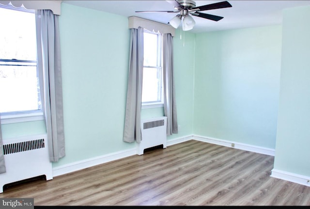 empty room with radiator and a healthy amount of sunlight