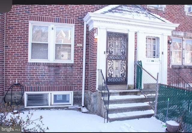 view of snow covered property entrance