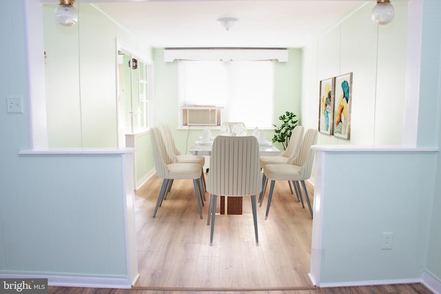 dining room featuring light hardwood / wood-style floors and cooling unit