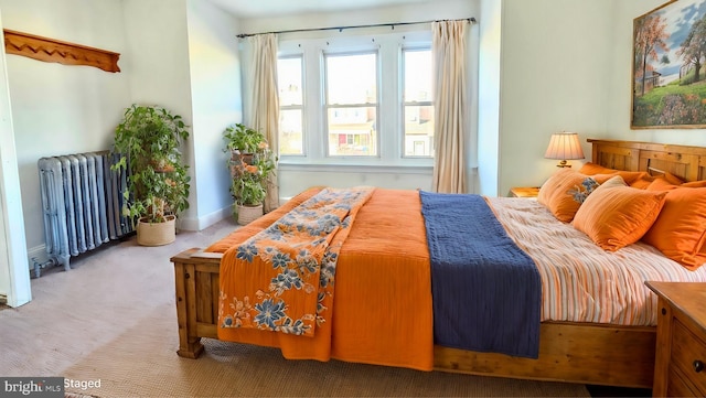 carpeted bedroom featuring radiator