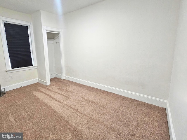 unfurnished bedroom with carpet flooring and a closet