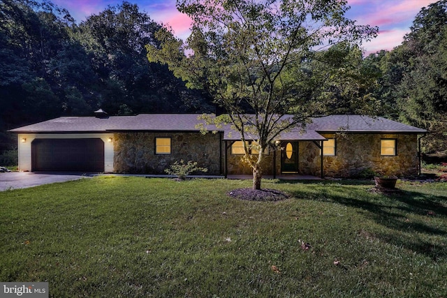 ranch-style house with a yard and a garage