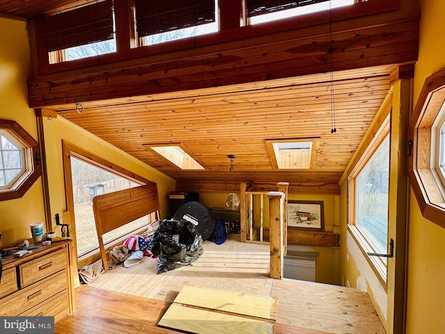 additional living space with wood ceiling and a skylight