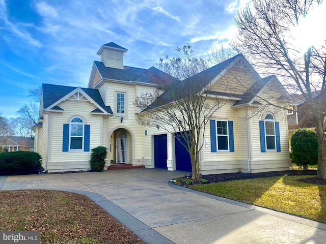 view of front of house featuring a garage and a front lawn