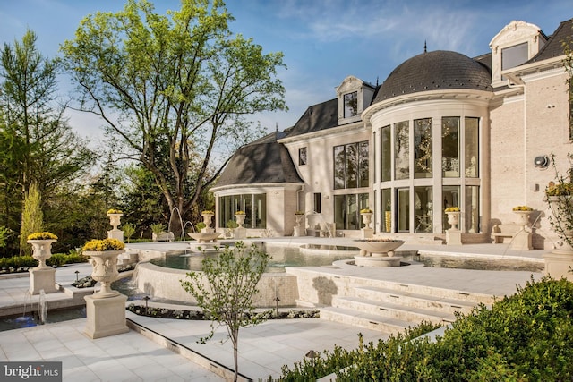 back of property with a patio area