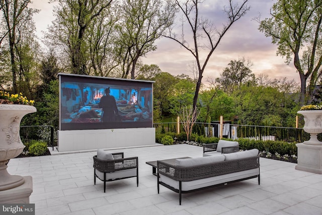 patio terrace at dusk featuring outdoor lounge area