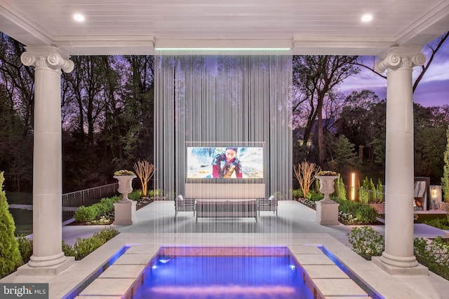 pool at dusk with a patio