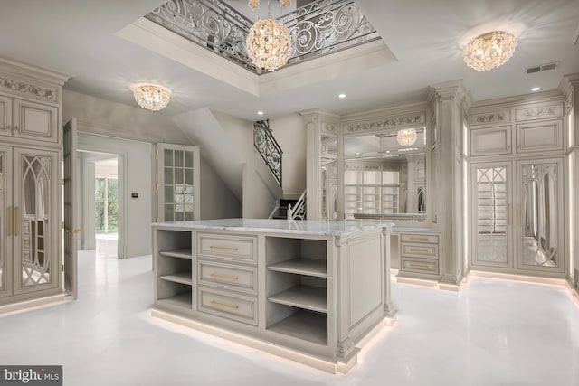 walk in closet with a chandelier