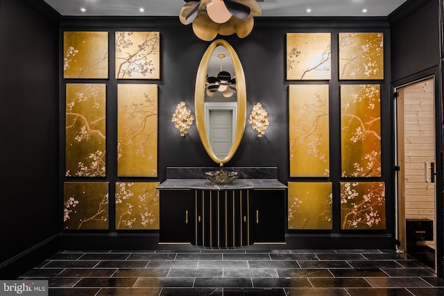 bathroom featuring ceiling fan, vanity, and ornamental molding