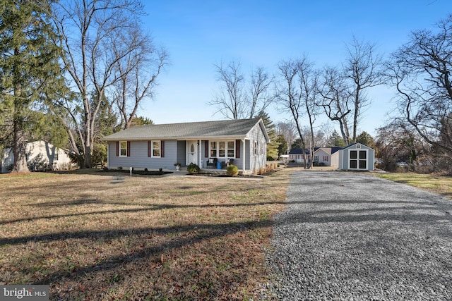 ranch-style house with a storage shed and a front yard