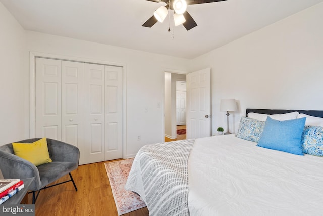 bedroom with ceiling fan, a closet, and light hardwood / wood-style floors