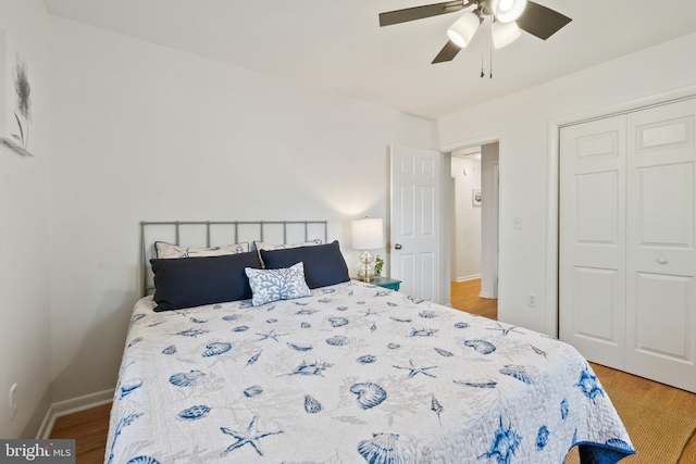 bedroom with ceiling fan, hardwood / wood-style floors, and a closet