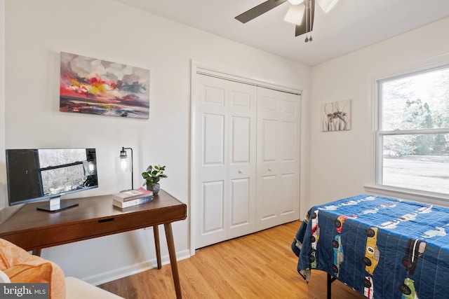 bedroom with ceiling fan, hardwood / wood-style floors, and a closet