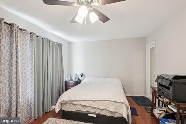 bedroom featuring ceiling fan and dark hardwood / wood-style flooring