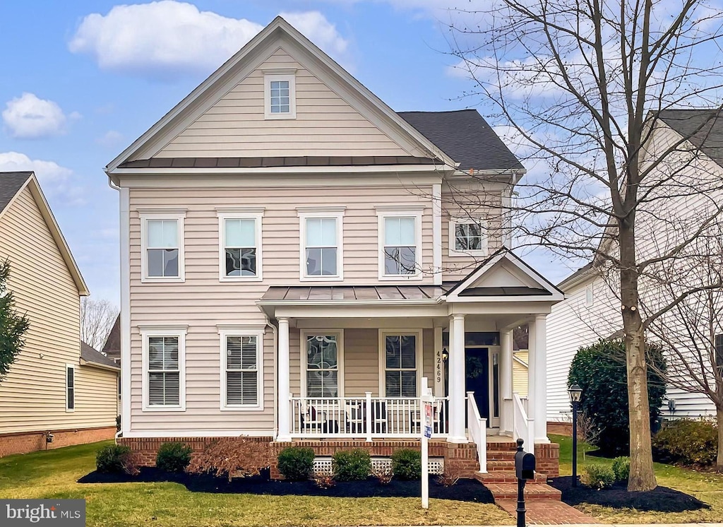 view of front of house with a front lawn and covered porch