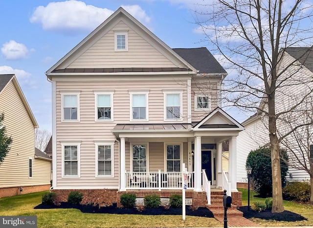 view of front of house with a front lawn and covered porch