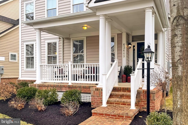 view of exterior entry with covered porch