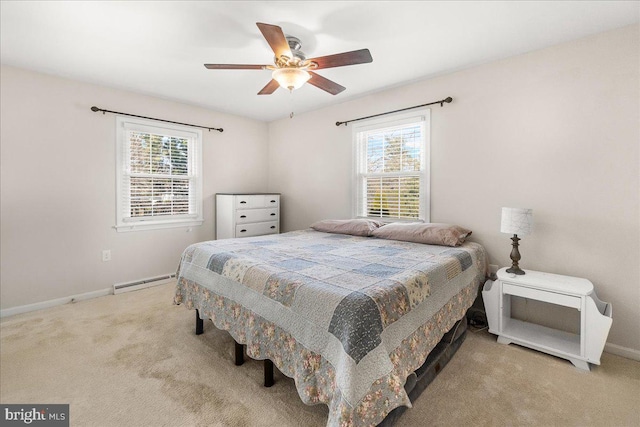 carpeted bedroom featuring ceiling fan, multiple windows, and a baseboard radiator