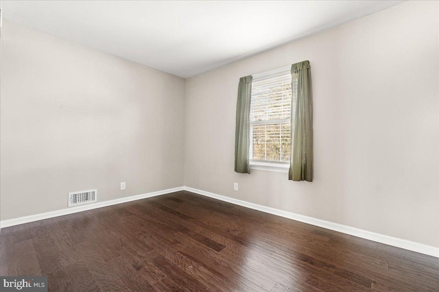 unfurnished room with wood-type flooring