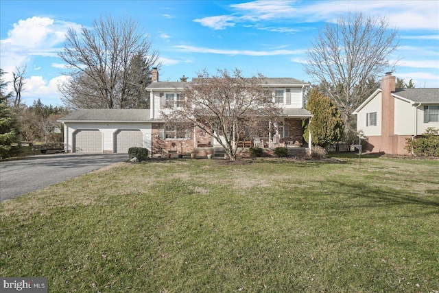 view of front of home featuring a garage and a front lawn