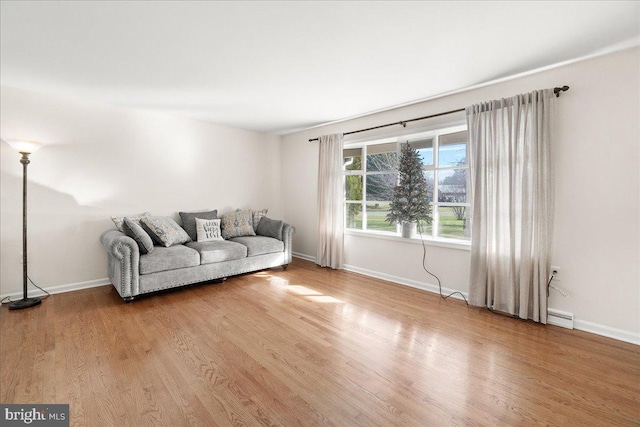 unfurnished living room featuring hardwood / wood-style floors and a baseboard radiator