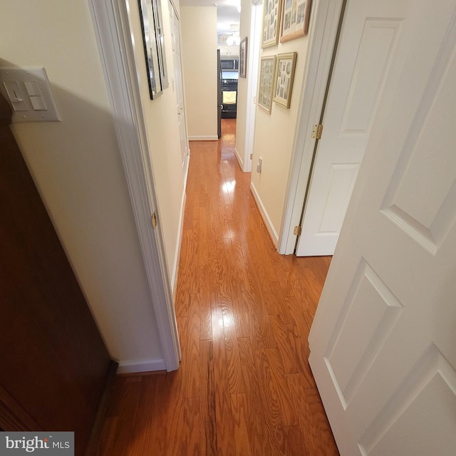 corridor featuring light hardwood / wood-style floors