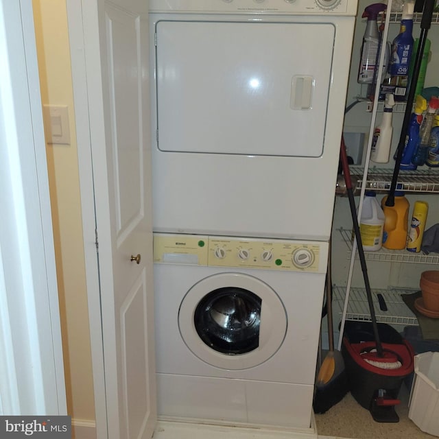 laundry area with stacked washer / drying machine