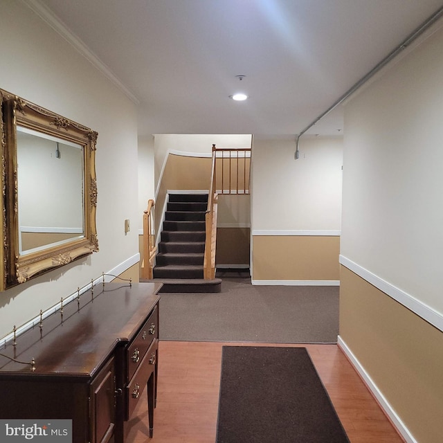 corridor featuring ornamental molding and light hardwood / wood-style flooring