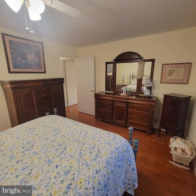 bedroom featuring ceiling fan and dark hardwood / wood-style floors