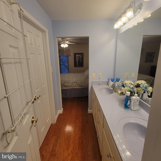 bathroom featuring ceiling fan, vanity, and hardwood / wood-style flooring