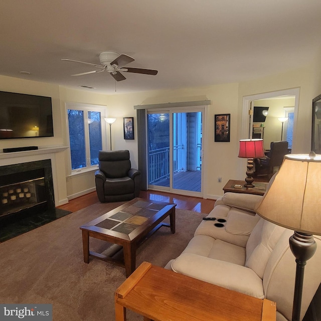 living room featuring ceiling fan and dark wood-type flooring