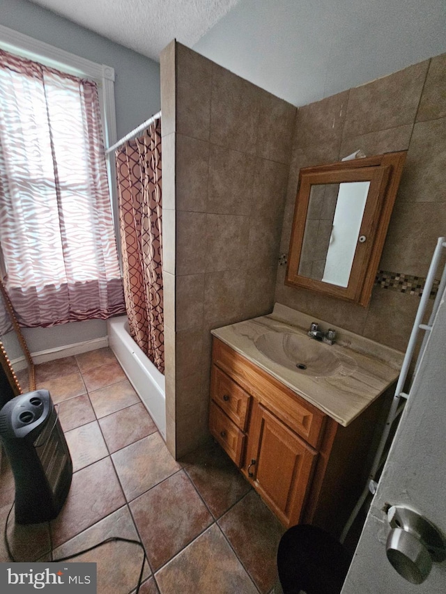 bathroom with tile patterned flooring, vanity, shower / bathtub combination with curtain, and tile walls