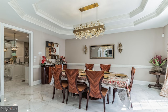 dining area featuring an inviting chandelier, crown molding, and a tray ceiling