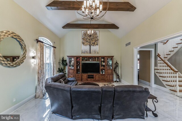 living room featuring high vaulted ceiling and a notable chandelier