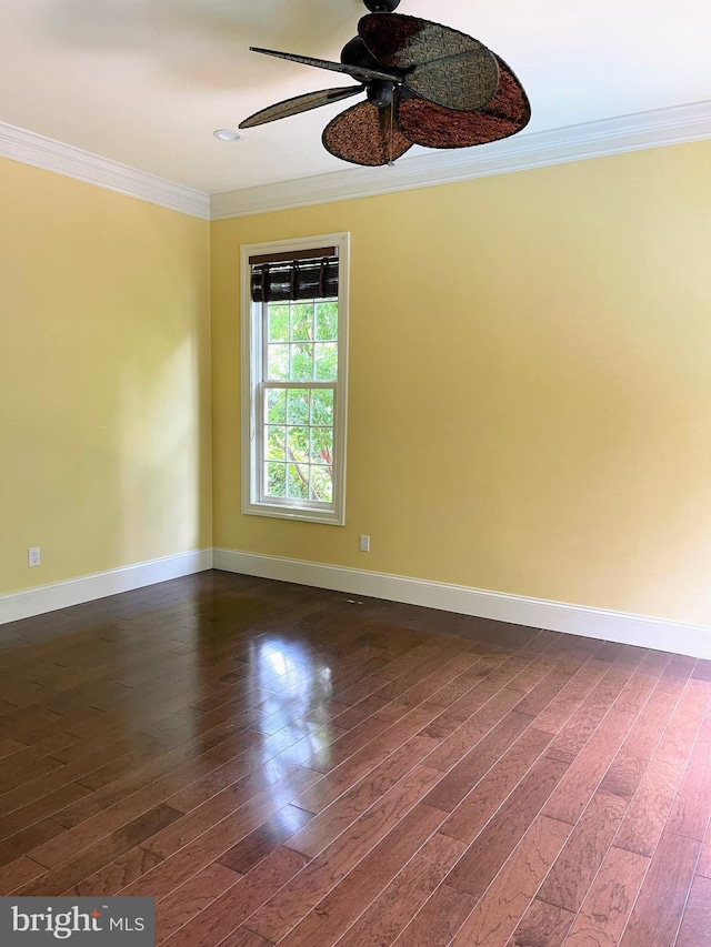 empty room with dark hardwood / wood-style flooring, ceiling fan, and ornamental molding