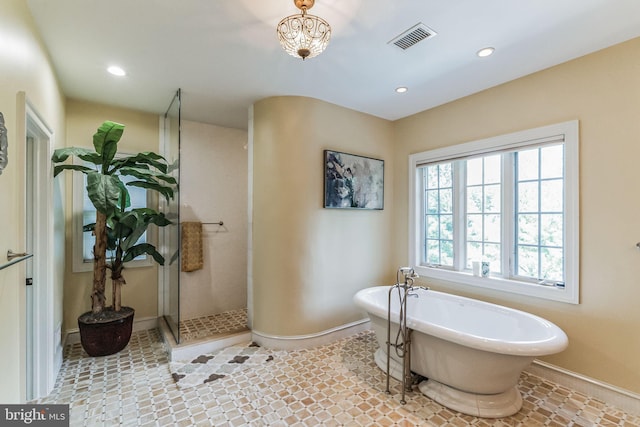 bathroom featuring separate shower and tub