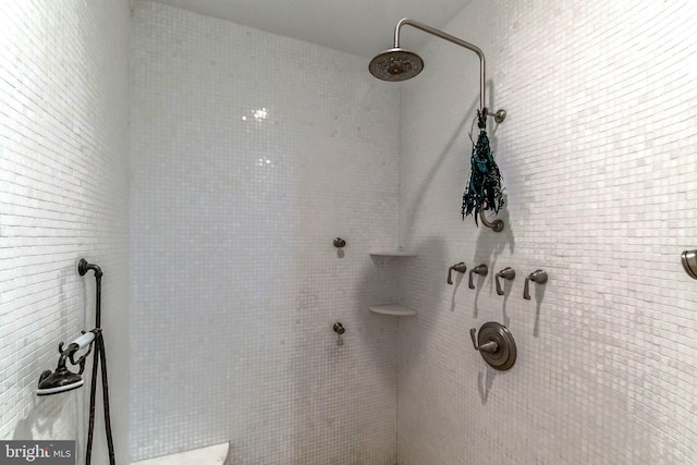 bathroom with tiled shower