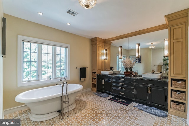 bathroom with vanity and a tub