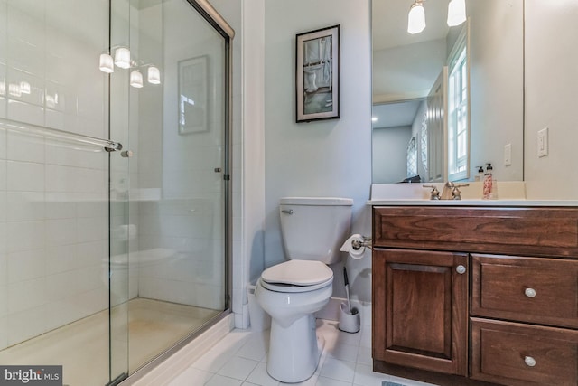 bathroom with tile patterned flooring, vanity, toilet, and a shower with shower door