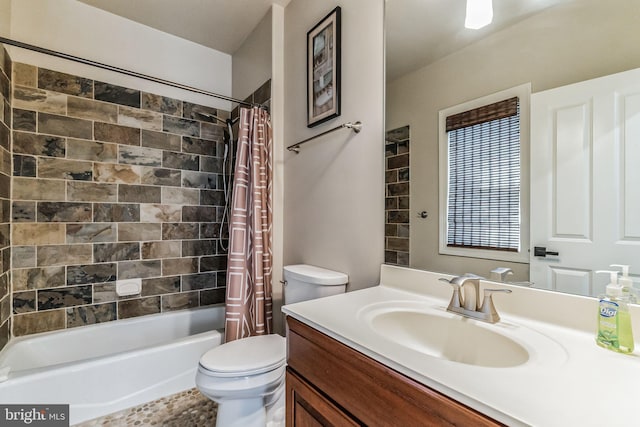 full bathroom with shower / bath combo with shower curtain, vanity, and toilet