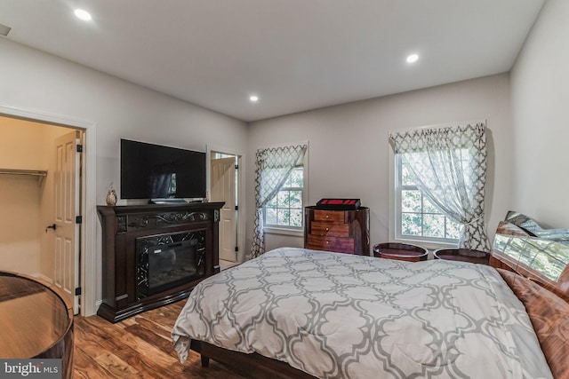 bedroom featuring light wood-type flooring and a walk in closet