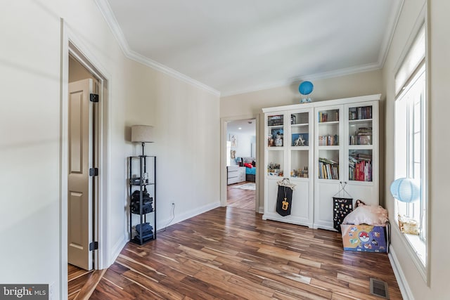 interior space featuring dark wood-type flooring and ornamental molding