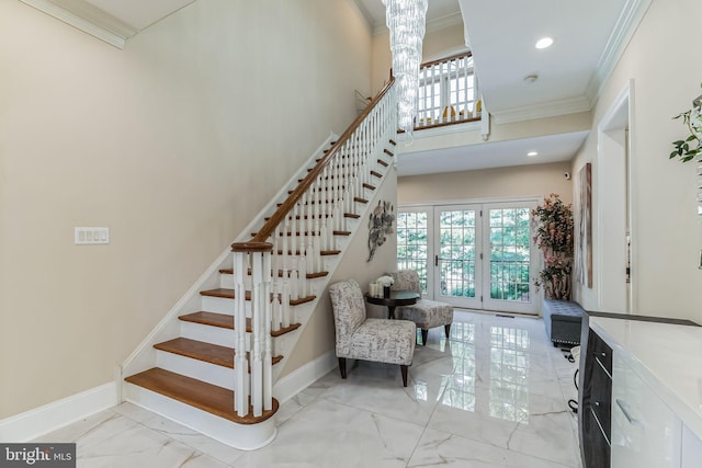 stairs with a chandelier, ornamental molding, and french doors