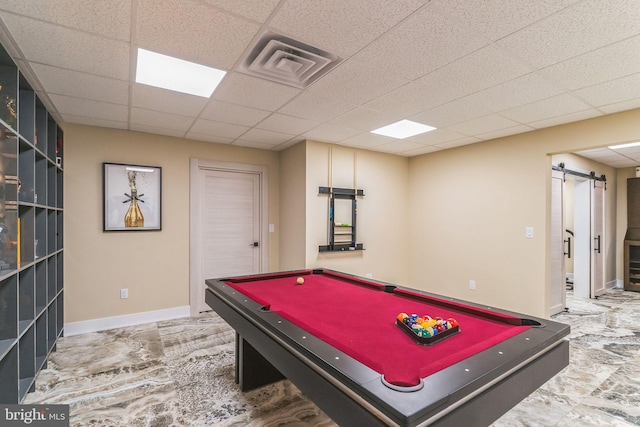 game room with a drop ceiling, a barn door, and pool table