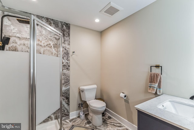 bathroom with vanity, toilet, and a shower with shower door