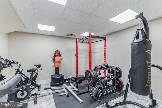 workout room featuring a paneled ceiling