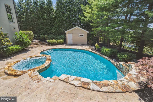 view of pool with a patio and an outdoor structure