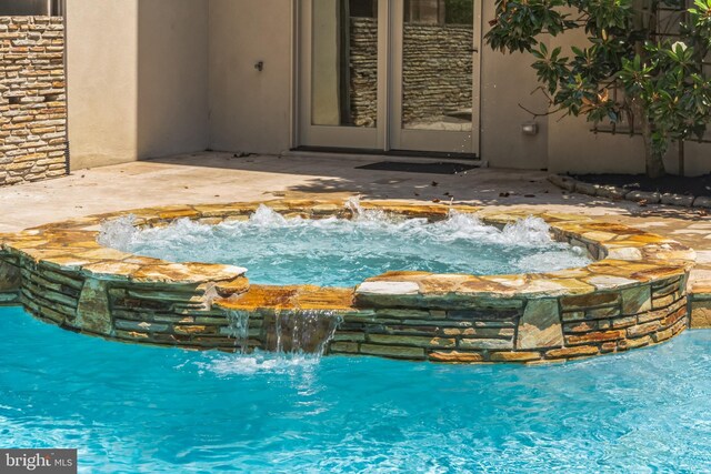 view of pool with pool water feature