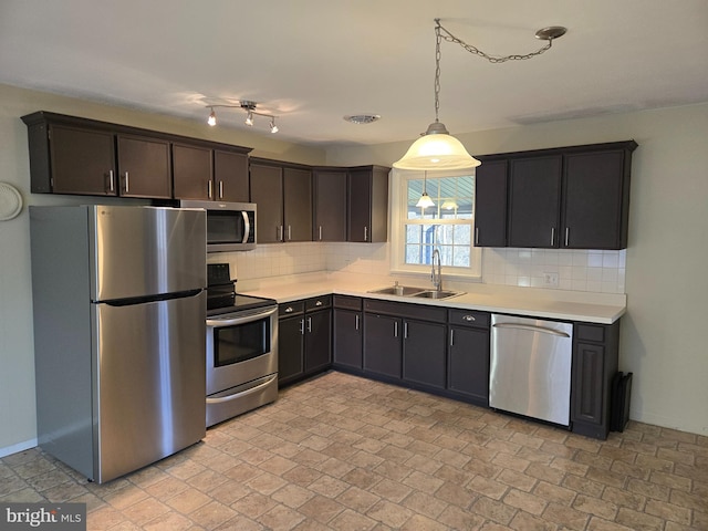 kitchen with tasteful backsplash, dark brown cabinetry, sink, and appliances with stainless steel finishes