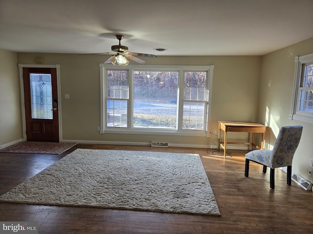 foyer with dark hardwood / wood-style floors and ceiling fan